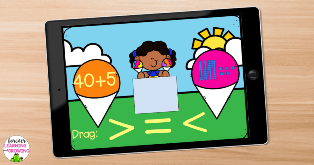 an ipad on a desk showing a boom card deck for place value to 99. 40+5 is on one snow cone and 45 is shown in base 10 blocks on another. There is space in the middle to drag the greater than, less than, or equal to symbol to compare the numbers