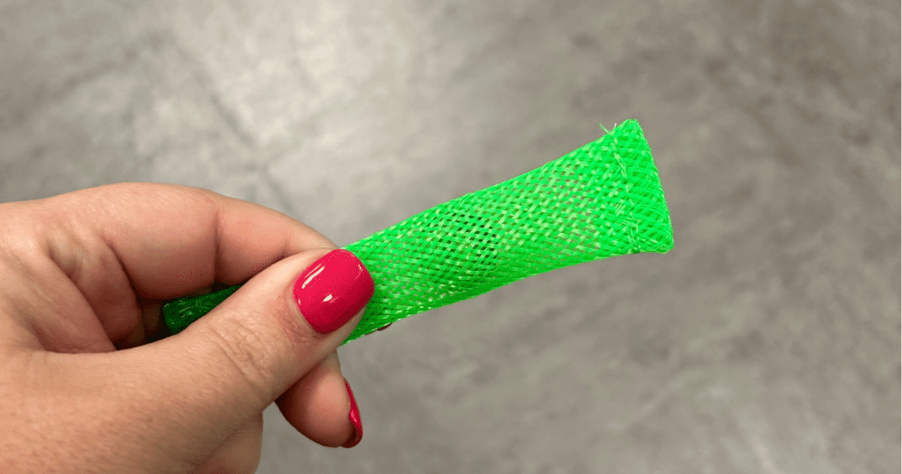 person holding green mesh marble fidget